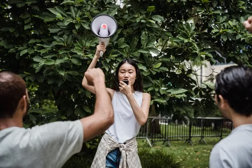 A young leader with a megaphone organizing a community action